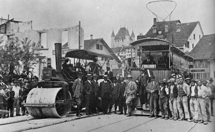 SW-02​Another image taken on the same day with the dignitaries and workers posing for a souvenir picture. Schloss Thun can be seen above the buildings in the background. Note the planks on the ground - presumably so as not to damage the road surface.